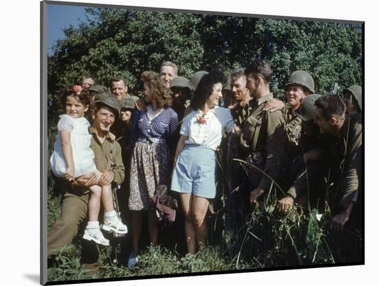 U.S. Soldiers Gather around a French Girl Near Avranches, France, August 1944-Frank Scherschel-Mounted Photographic Print