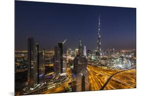 UAE, Downtown Dubai. Cityscape with Burj Khalifa at night.-Walter Bibikow-Mounted Premium Photographic Print
