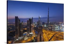 UAE, Downtown Dubai. Cityscape with Burj Khalifa at night.-Walter Bibikow-Stretched Canvas