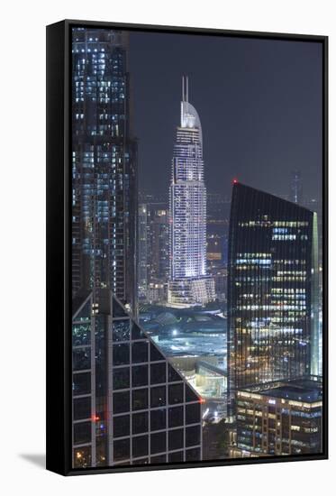 UAE, Downtown Dubai. Downtown cityscape at night lit in blue.-Walter Bibikow-Framed Stretched Canvas