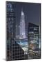 UAE, Downtown Dubai. Downtown cityscape at night lit in blue.-Walter Bibikow-Mounted Photographic Print