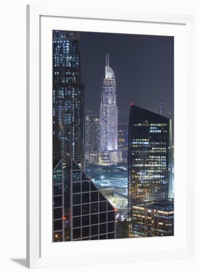 UAE, Downtown Dubai. Downtown cityscape at night lit in blue.-Walter Bibikow-Framed Premium Photographic Print