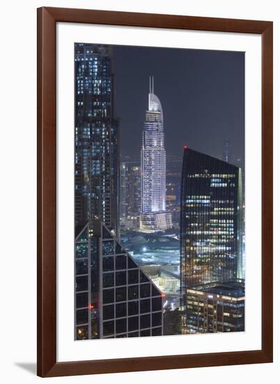 UAE, Downtown Dubai. Downtown cityscape at night lit in blue.-Walter Bibikow-Framed Premium Photographic Print