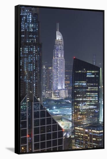 UAE, Downtown Dubai. Downtown cityscape at night lit in blue.-Walter Bibikow-Framed Stretched Canvas