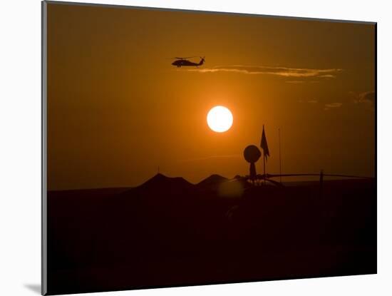 UH-60 Blackhawk Flies over Camp Speicher Airfield at Sunset-Stocktrek Images-Mounted Photographic Print