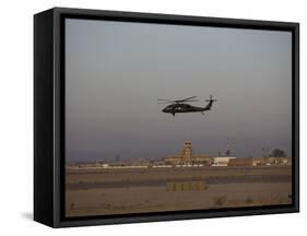 UH-60 Blackhawk Helicopter Flies Past the Tower on Camp Speicher-Stocktrek Images-Framed Stretched Canvas