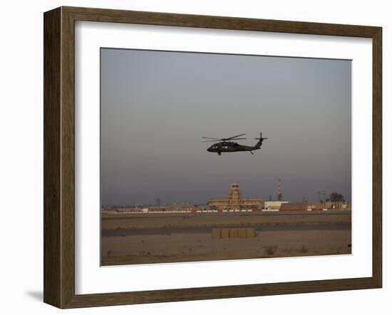 UH-60 Blackhawk Helicopter Flies Past the Tower on Camp Speicher-Stocktrek Images-Framed Photographic Print