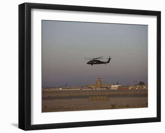 UH-60 Blackhawk Helicopter Flies Past the Tower on Camp Speicher-Stocktrek Images-Framed Photographic Print