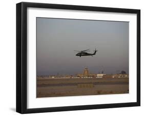 UH-60 Blackhawk Helicopter Flies Past the Tower on Camp Speicher-Stocktrek Images-Framed Photographic Print