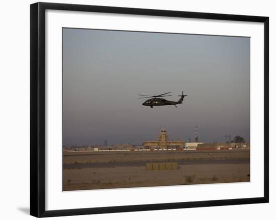 UH-60 Blackhawk Helicopter Flies Past the Tower on Camp Speicher-Stocktrek Images-Framed Photographic Print