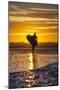 Uk, Cornwall, Polzeath. a Woman Comes in from an Evening Surf Against a Stunning Sunset.-Niels Van Gijn-Mounted Photographic Print