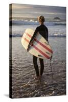 Uk, Cornwall, Polzeath. a Woman Looks Out to See, Preparing for an Evening Surf. Mr-Niels Van Gijn-Stretched Canvas