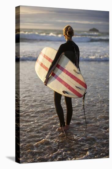 Uk, Cornwall, Polzeath. a Woman Looks Out to See, Preparing for an Evening Surf. Mr-Niels Van Gijn-Stretched Canvas