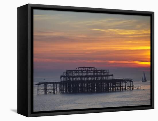 UK, England, Sussex, Brighton, Boat Sailing Past Remains of Brighton West Pier at Sunset-Jane Sweeney-Framed Stretched Canvas