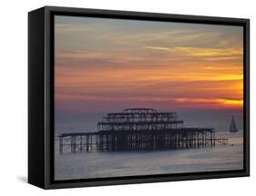 UK, England, Sussex, Brighton, Boat Sailing Past Remains of Brighton West Pier at Sunset-Jane Sweeney-Framed Stretched Canvas