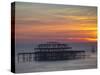UK, England, Sussex, Brighton, Boat Sailing Past Remains of Brighton West Pier at Sunset-Jane Sweeney-Stretched Canvas