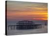 UK, England, Sussex, Brighton, Boat Sailing Past Remains of Brighton West Pier at Sunset-Jane Sweeney-Stretched Canvas