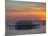 UK, England, Sussex, Brighton, Boat Sailing Past Remains of Brighton West Pier at Sunset-Jane Sweeney-Mounted Photographic Print