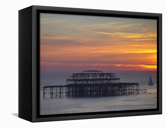 UK, England, Sussex, Brighton, Boat Sailing Past Remains of Brighton West Pier at Sunset-Jane Sweeney-Framed Stretched Canvas