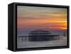 UK, England, Sussex, Brighton, Boat Sailing Past Remains of Brighton West Pier at Sunset-Jane Sweeney-Framed Stretched Canvas