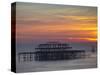 UK, England, Sussex, Brighton, Boat Sailing Past Remains of Brighton West Pier at Sunset-Jane Sweeney-Stretched Canvas