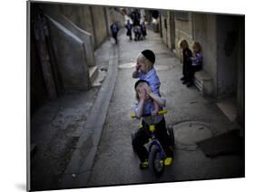 Ultra-Orthodox Jewish Children Cover their Faces as They Play in a Street in Jerusalem-null-Mounted Photographic Print