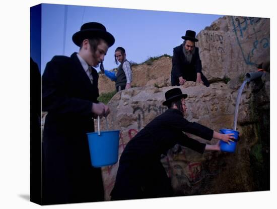 Ultra-Orthodox Jewish Men Stand Next to a Well as They Fill Canisters with Water in Jerusalem-null-Stretched Canvas