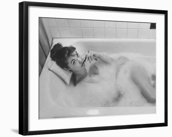 Unexposed Nude Woman in the Bathtub Amid the Bubbles While Smoking a Cigarette-Peter Stackpole-Framed Photographic Print