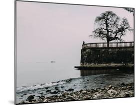 Unidentified woman looking at Lake Maggiore on a cold winter's day, Piedmont, Italian Lakes, Italy,-Alexandre Rotenberg-Mounted Photographic Print