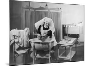 Uniformed Nurse Bathes a Baby in Hospital-null-Mounted Photographic Print