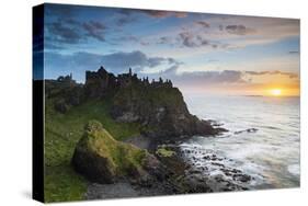 United Kingdom, Northern Ireland, County Antrim, Bushmills. The ruins of the 13th century Dunluce C-Nick Ledger-Stretched Canvas