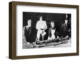 Unwrapping a Mummy-null-Framed Photographic Print