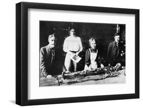 Unwrapping a Mummy-null-Framed Photographic Print