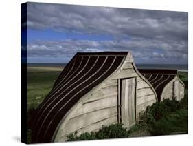 Upturned Boats Used as Sheds, Lindisfarne (Holy Island), Northumbria, England-Jean Brooks-Stretched Canvas