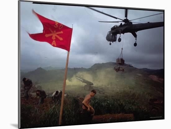 US 1st Air Cavalry Skycrane Helicopter Delivering Ammunition and Supplies to Besieged Marines-Larry Burrows-Mounted Photographic Print