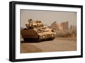 US Bradley Fighting Vehicle Passes by the Palace of Historic Ctesiphon, Feb. 16, 2008-null-Framed Photo