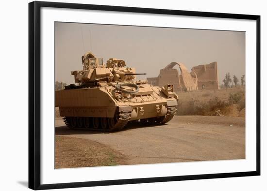 US Bradley Fighting Vehicle Passes by the Palace of Historic Ctesiphon, Feb. 16, 2008-null-Framed Photo