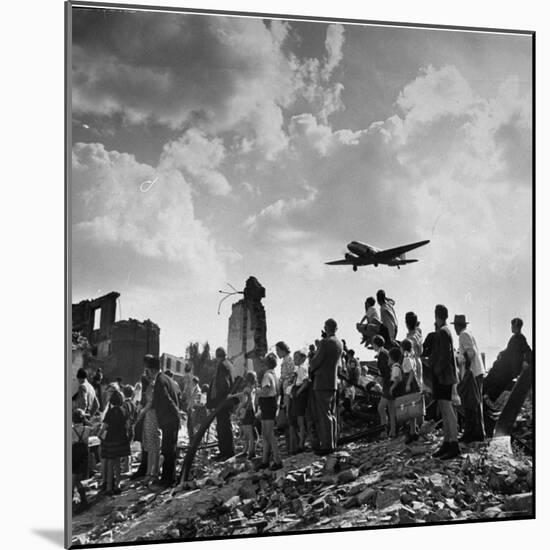 US C-47 Cargo Plane Flying over Ruins, Approaching Tempelhof Airport with Food and Supplies-Walter Sanders-Mounted Photographic Print