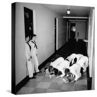 US Coast Guard Academy, Lower Classmen Bowing over Books, Hoping for Luck in Examinations-William C^ Shrout-Stretched Canvas