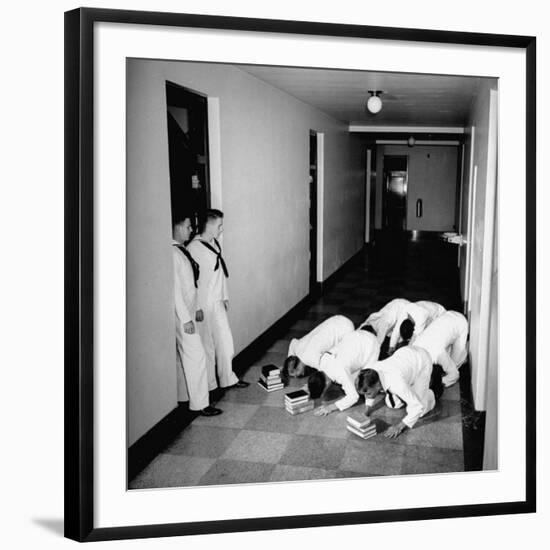 US Coast Guard Academy, Lower Classmen Bowing over Books, Hoping for Luck in Examinations-William C^ Shrout-Framed Photographic Print