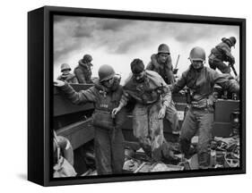 US Coast Guardsmen Assisting a Wounded Marine Returning from the Fight on Iwo Jima-null-Framed Stretched Canvas