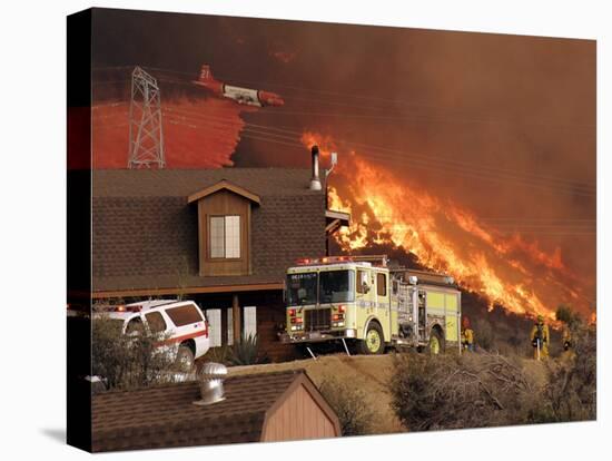 US Forest Service Air Tanker Drops Fire Retardant as the Fire Burns in the Hills Above a Home-null-Stretched Canvas