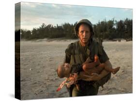 US Marine Holding an Injured Vietnamese Child-Paul Schutzer-Stretched Canvas