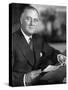 US Pres. Franklin D. Roosevelt Sitting at Desk and Holding Piece of Paper in Office, in White House-null-Stretched Canvas