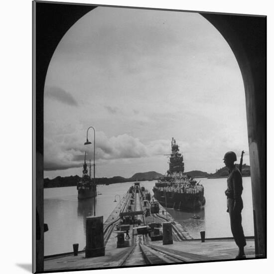 US Soldier Standing Guard over Section of Panama Canal, Battleship with Full Crew on Deck-Thomas D^ Mcavoy-Mounted Photographic Print