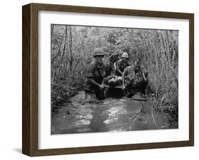 US Soldiers Carry a Wounded Comrade Through a Swampy Area in Vietnam, 1969-null-Framed Photo