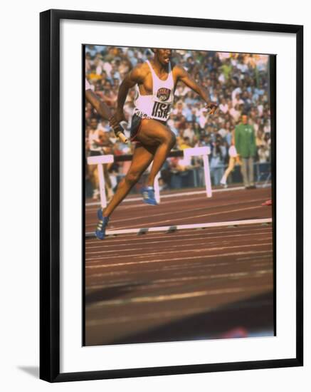 US Track Athlete Eddie Hart Running the 400 Meter Relay at the Summer Olympics-null-Framed Premium Photographic Print