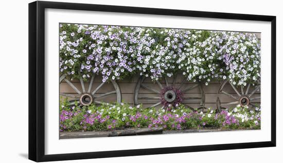 USA, Alaska, Chena Hot Springs. Flowers and wagon wheels.-Jaynes Gallery-Framed Photographic Print