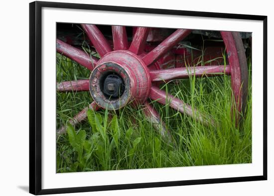 USA, Alaska, Chena Hot Springs. Vintage wagon wheel and grass.-Jaynes Gallery-Framed Photographic Print