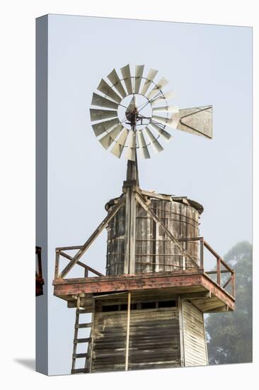 USA California. Cayucos, old wooden water tower with windmill for pumping-Alison Jones-Stretched Canvas